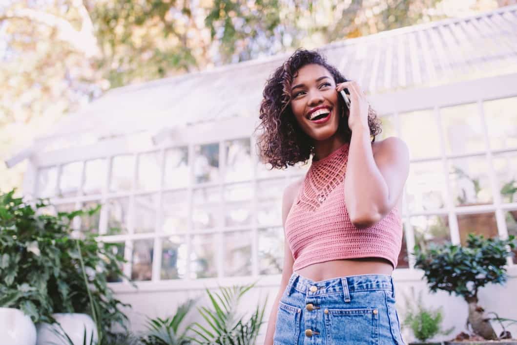 technology-smiling-woman-phone-smart-phone-happy-conversation-speaking-afro-american_t20_09y7Wv girl smiling speaking on the phone