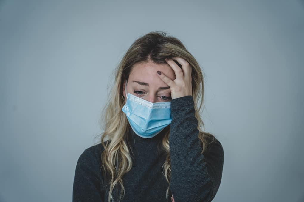 20 Positive Affirmations for Health Anxiety 3 woman looking very anxious wearing medical face mask