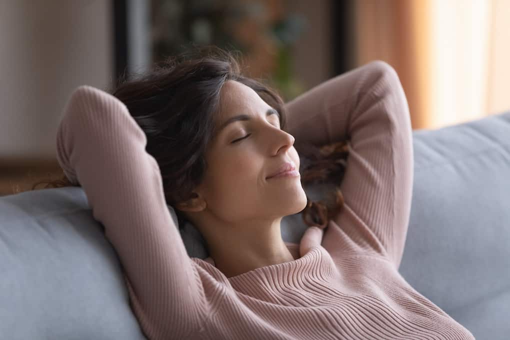 20 Positive Affirmations for Health Anxiety 5 woman slightly smiling with eyes closed looking calm