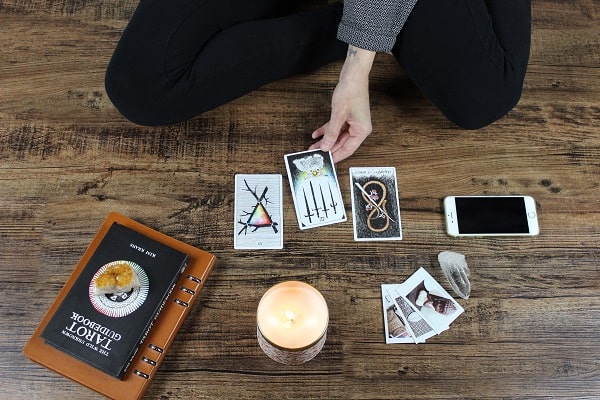 tarot for self improvement person pulling tarot on floor