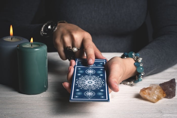 person pulling tarot cards