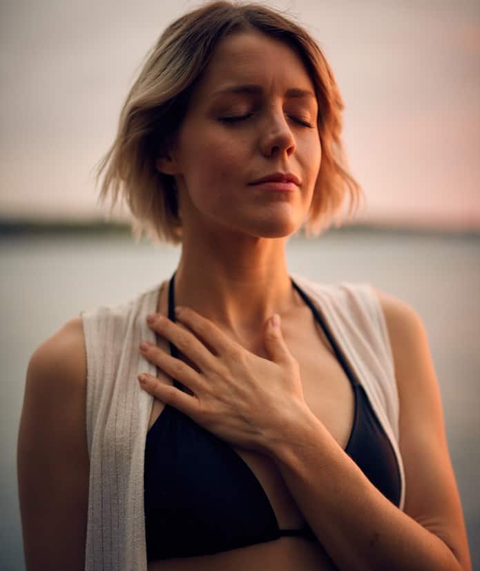 yoga breathing for stress relief woman breathing and holding chest