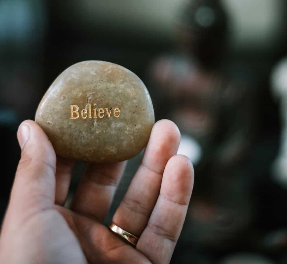 believe scripting law of attraction stone with the word believe engraved