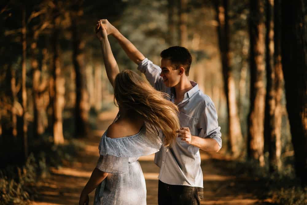 manifesting a specific person to love you couple dancing in woods