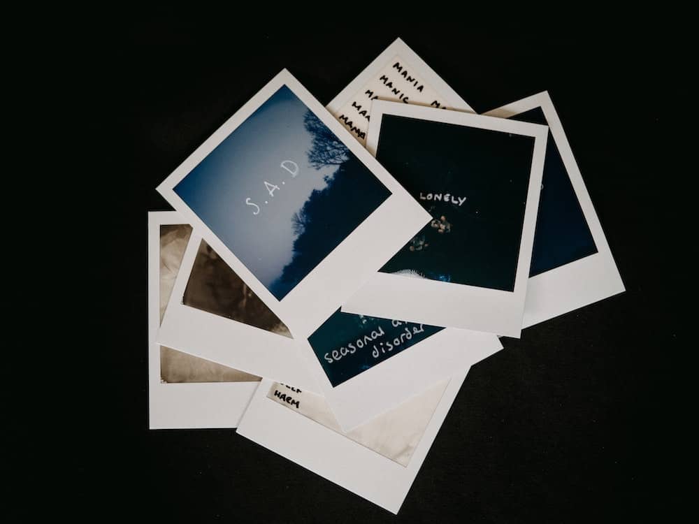 polaroids with mental health conditions written on them