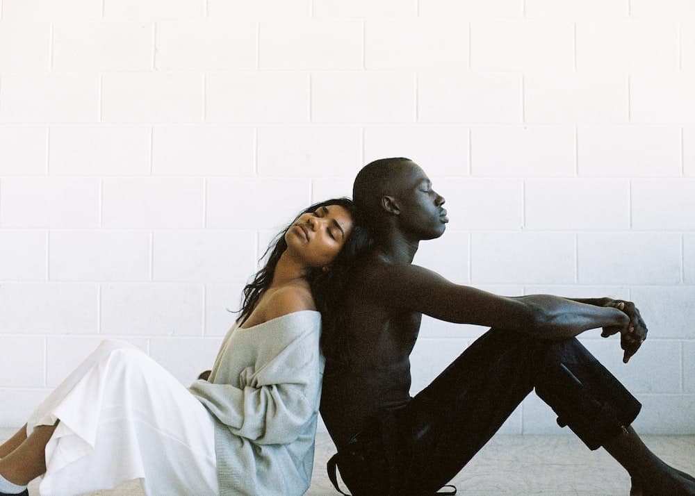 tips for manifesting a specific person couple sitting back to back