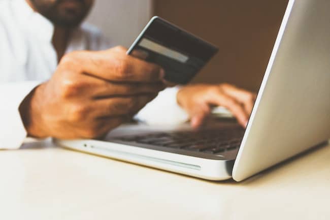 man spending money on computer
