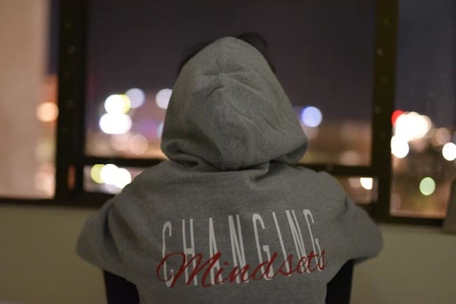 person wearing grey changing mindsets hoodie