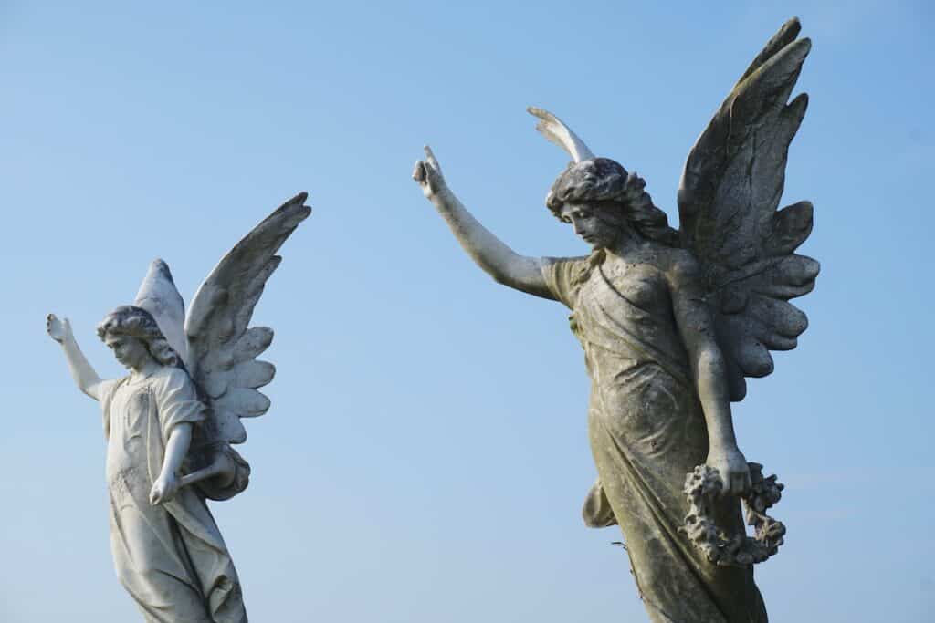 The 14 Best Angel Cards Decks for Healing in 2024 6 two statues of angels against blue sky