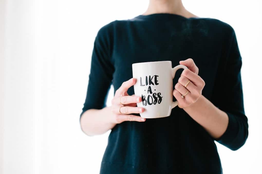 Manifesting a New Job or Career Change in 7 Easy Steps 9 woman holding mug which reads "like a boss"