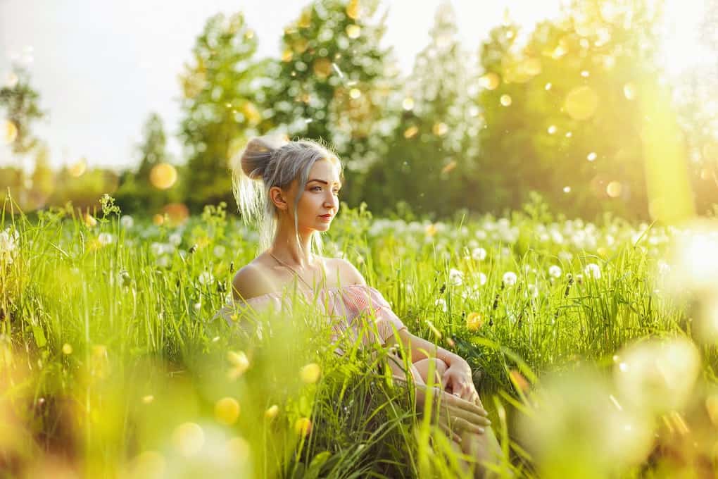 12 Spiritual Self Care Ideas for a Healthy Soul 6 girl sitting in nature among flowers