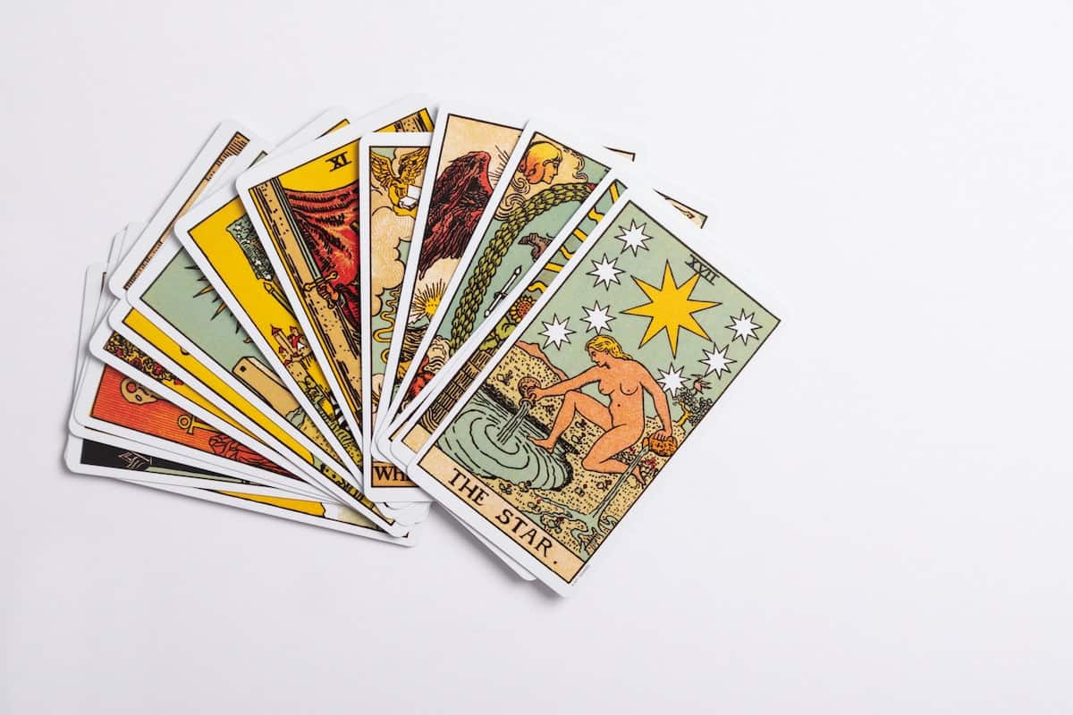 How to Use Tarot for Manifestation (and 12 Powerful Cards!) 1 pile of tarot cards with the star tarot card on top