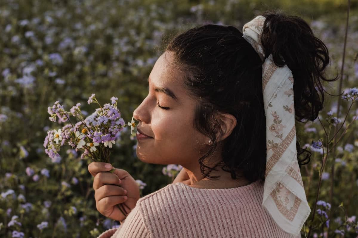 51 Powerful Mindfulness Journal Prompts for Self-Awareness 8 woman smelling flowers