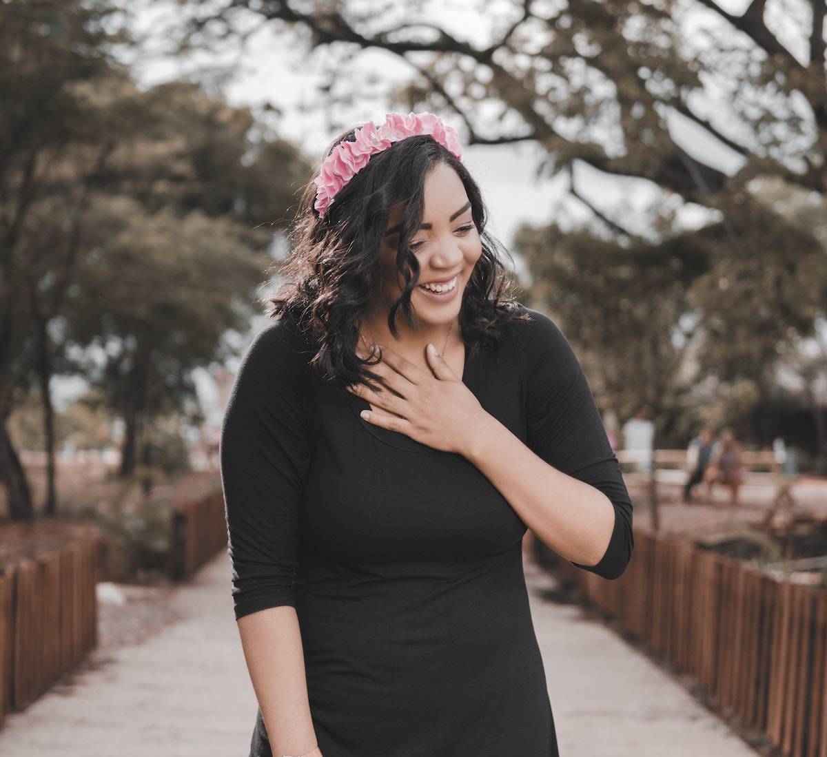 woman smiling placing hand on heart space