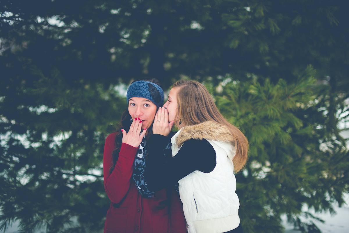 girls whispering and gossiping