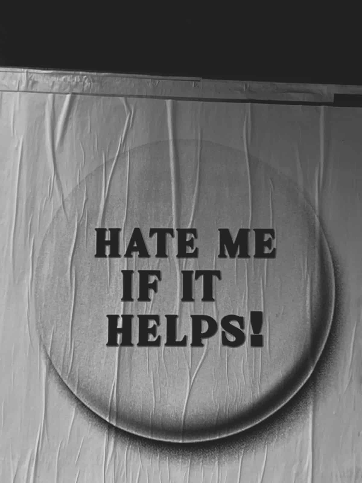 poster that reads "hate me if it helps!"