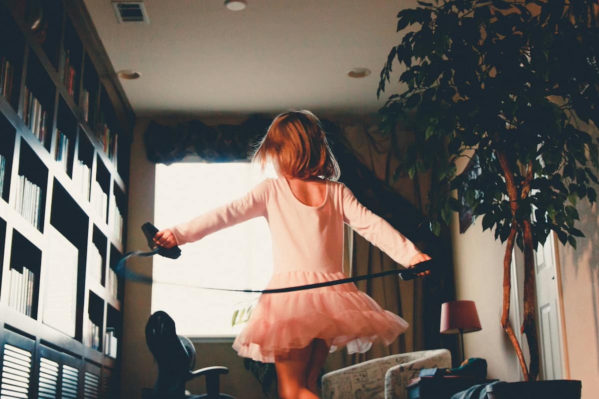 young girl dancing around room in ballet outfit