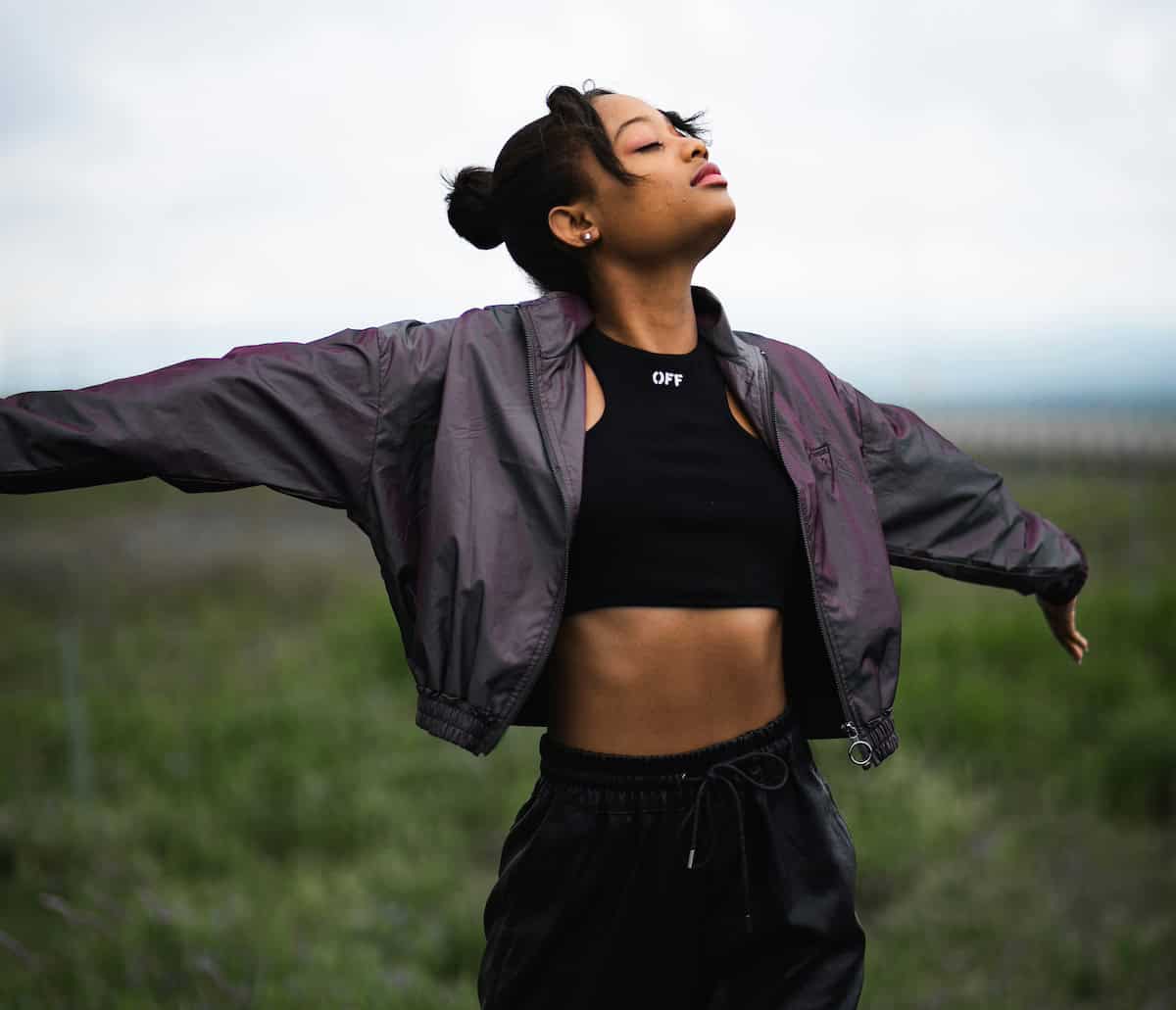 young woman in sports clothing looking mindful