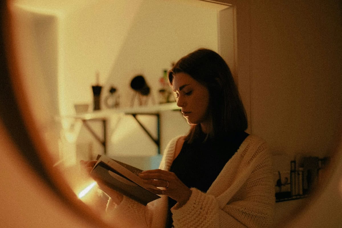 woman looking at journal in the evening